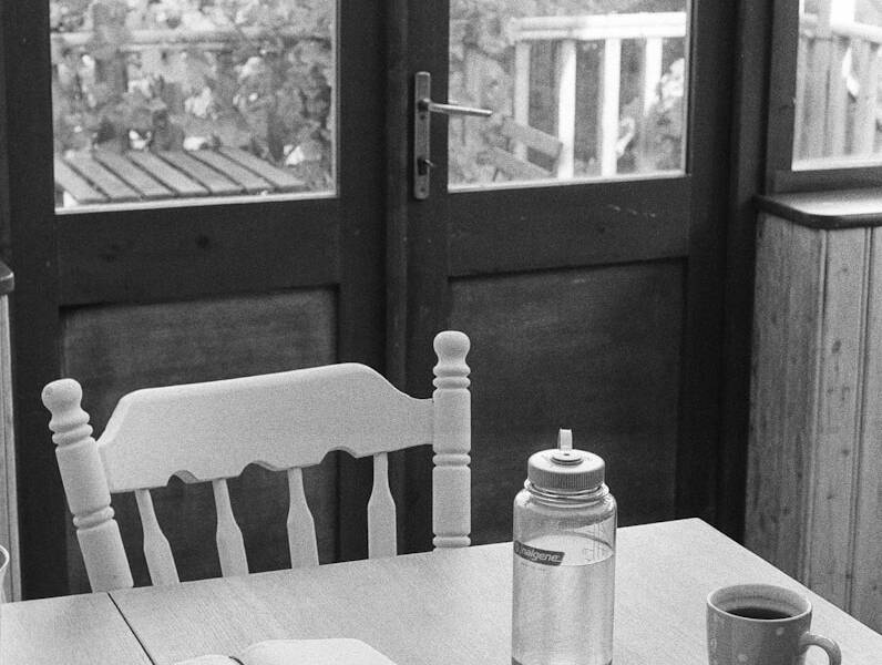 a table with a book and a cup on it